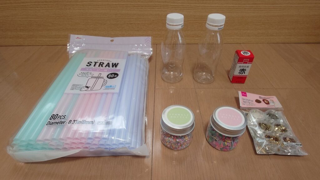 オイルタイマーDIYの材料の写真（8mmストロー、小さいペットボトル2個、食紅、100均のキラキラした飾り）